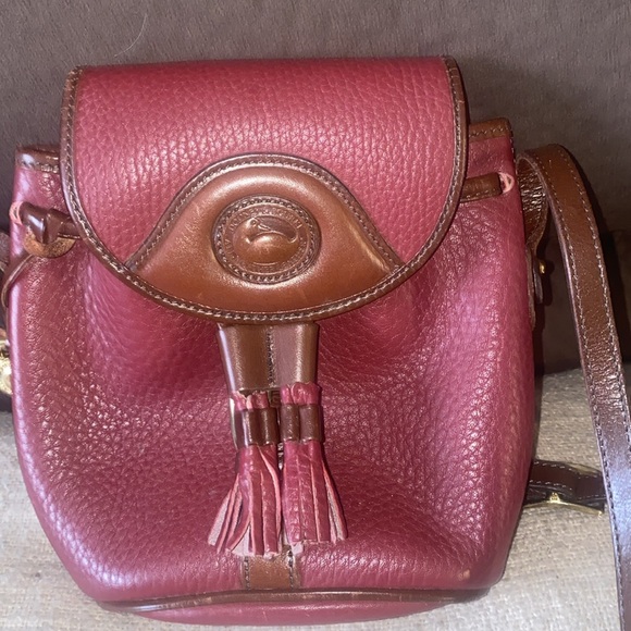 Dooney & Bourke Handbags - Dooney &  Burke burgundy red small leather purse maybe used once